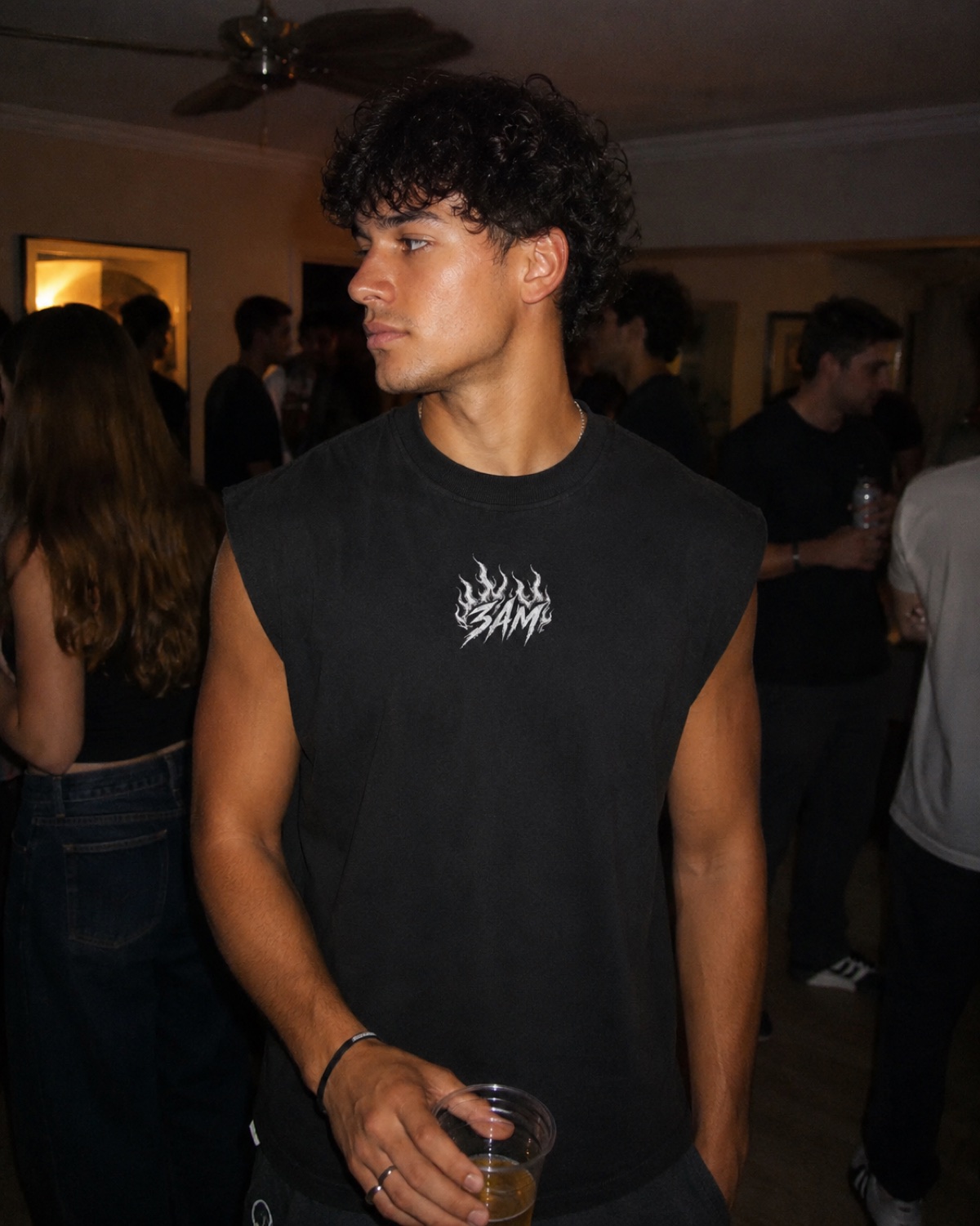 Man in the Burnout cutoff with the 3AM flame at a house party