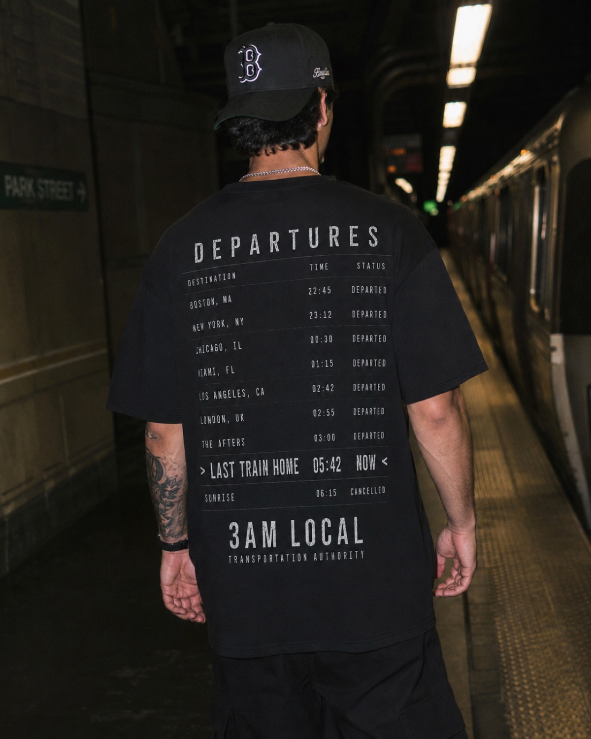 Last Train Home tee worn on a Boston train platform at night