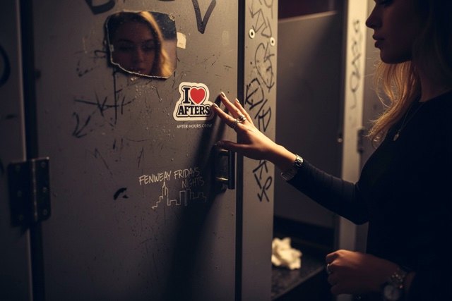 True Love sticker stuck on a club bathroom door at night