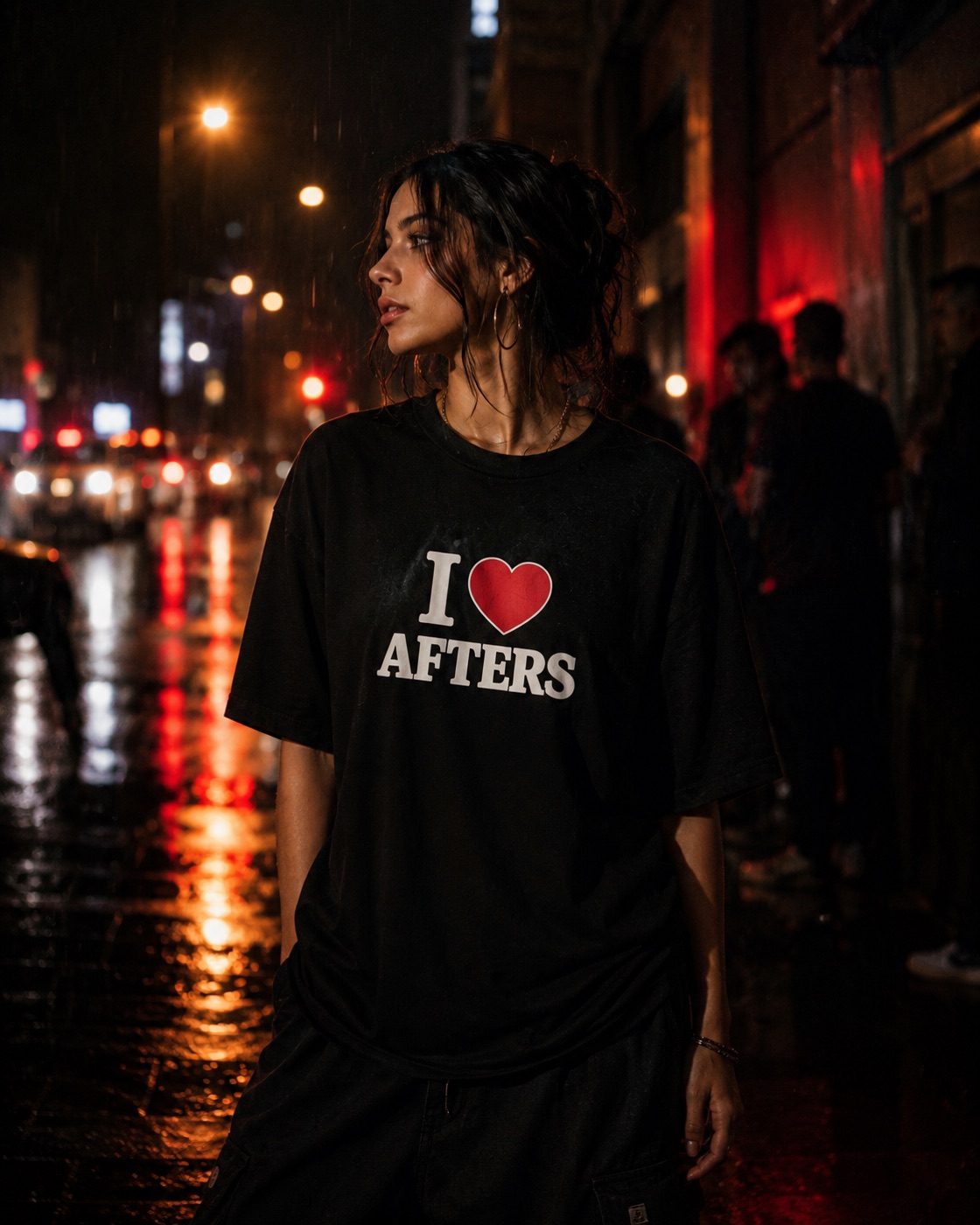 Woman in the black I heart Afters tee on a rain-slicked, red-lit Boston street at night